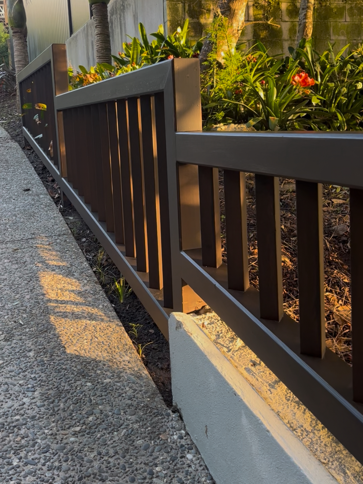 Cedar routed batten fence with precision-routed rails showcasing premium craftsmanship and natural timber finish in Auckland.