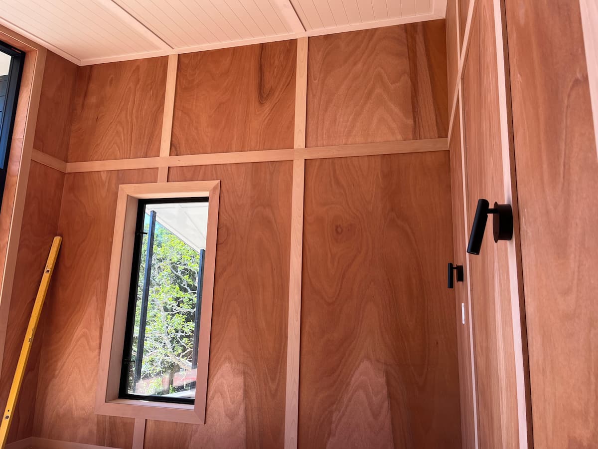 Gaboon plywood interior wall lining with vertical Okoume battens in a modern Auckland home