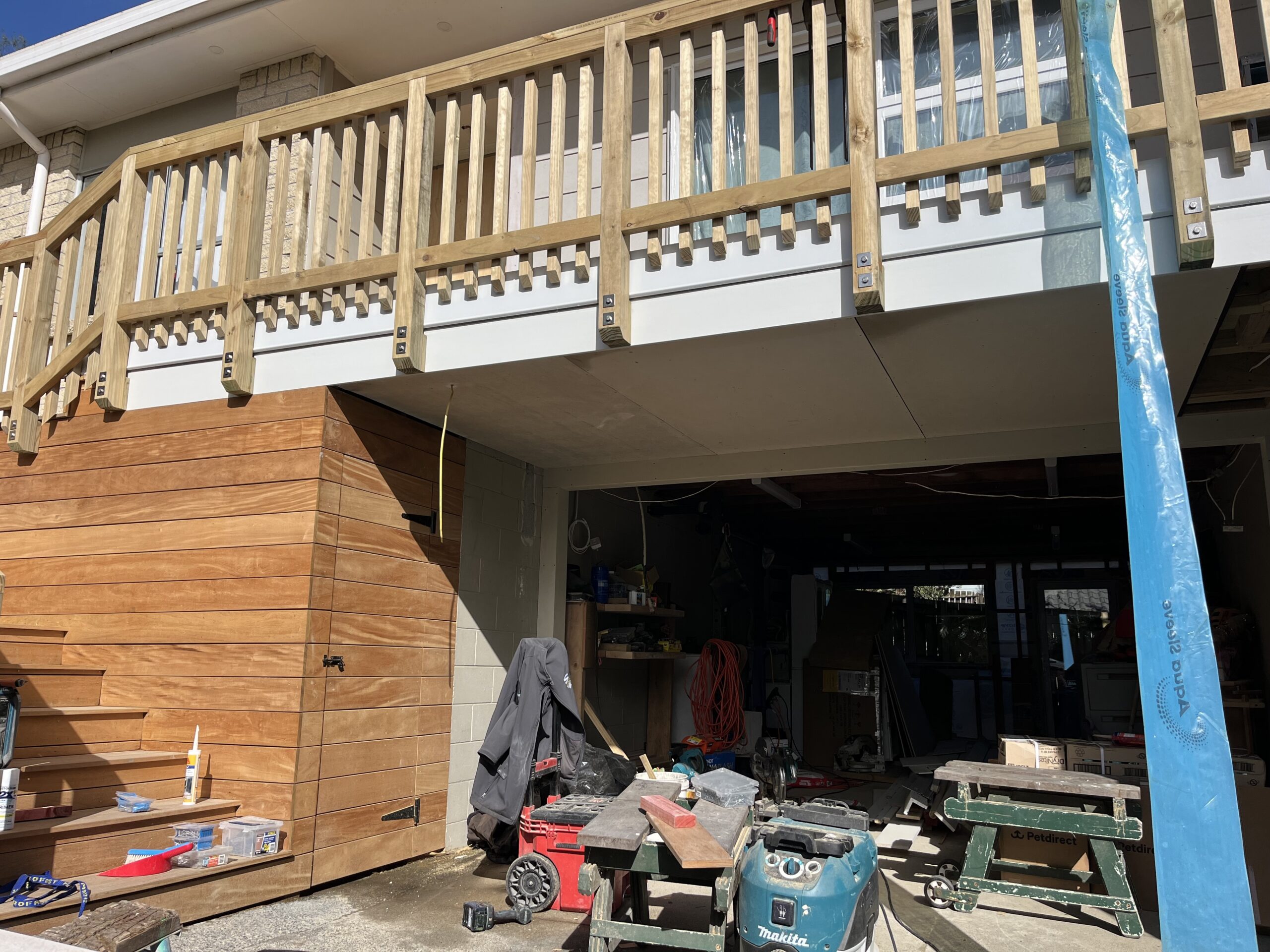 Garapa timber deck with custom timber balustrade and horizontal Garapa deck enclosure built by Macalister Construction in Auckland.